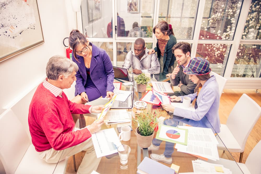 a team gathered at a table managing the details of an event they are planning