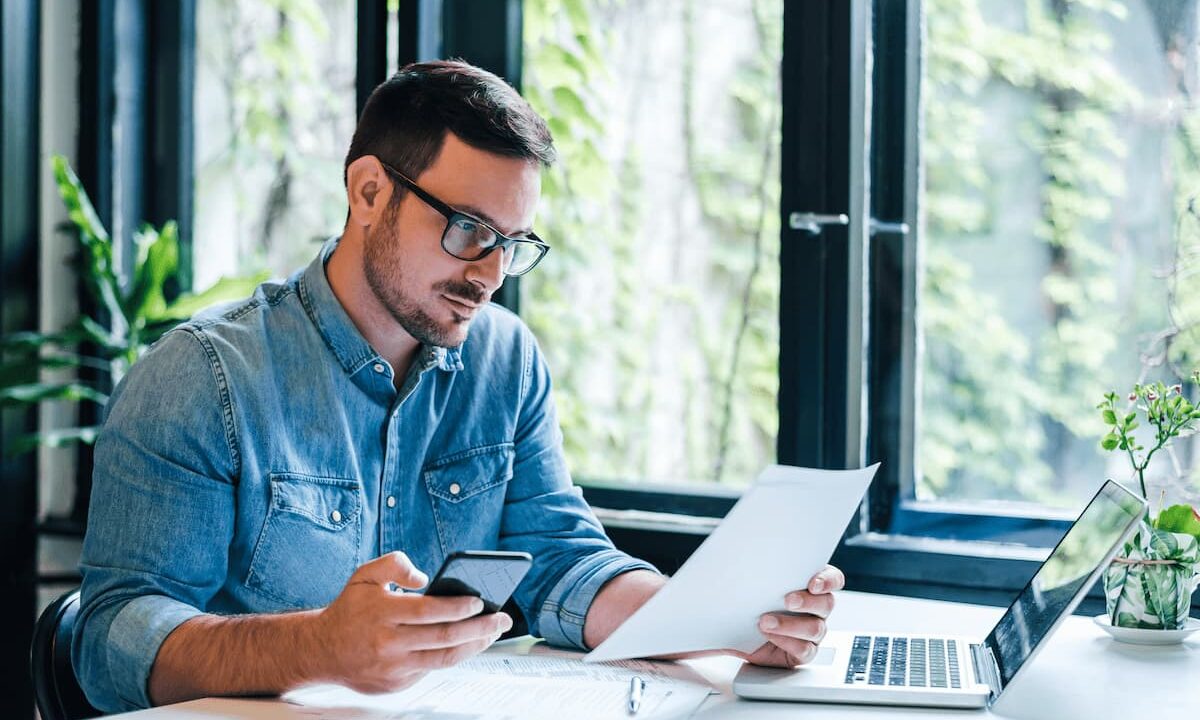 man at desk reviewing ticket pricing strategy for his conference