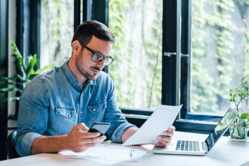 man at desk reviewing ticket pricing strategy for his conference