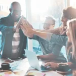 
                            team members give each other a high five                            