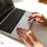 
                            A woman typing on a laptop.                            