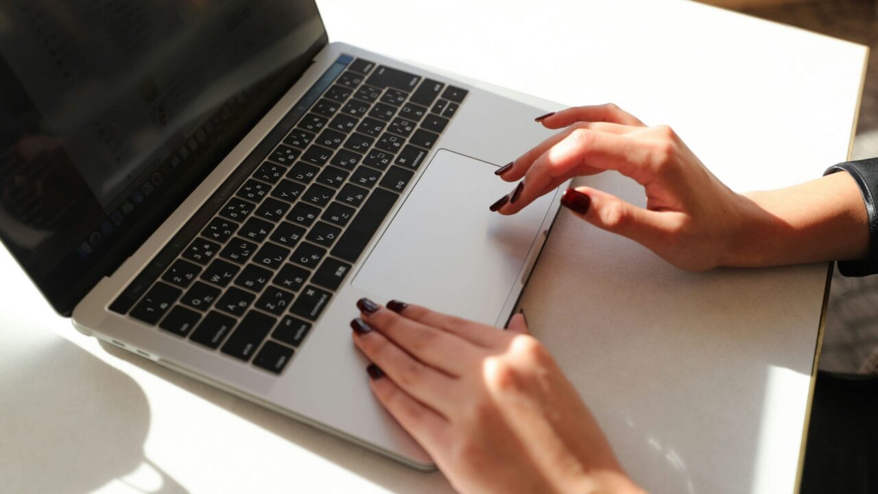 A woman typing on a laptop.