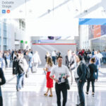 
                            A crowd walking down a tradeshow                            
